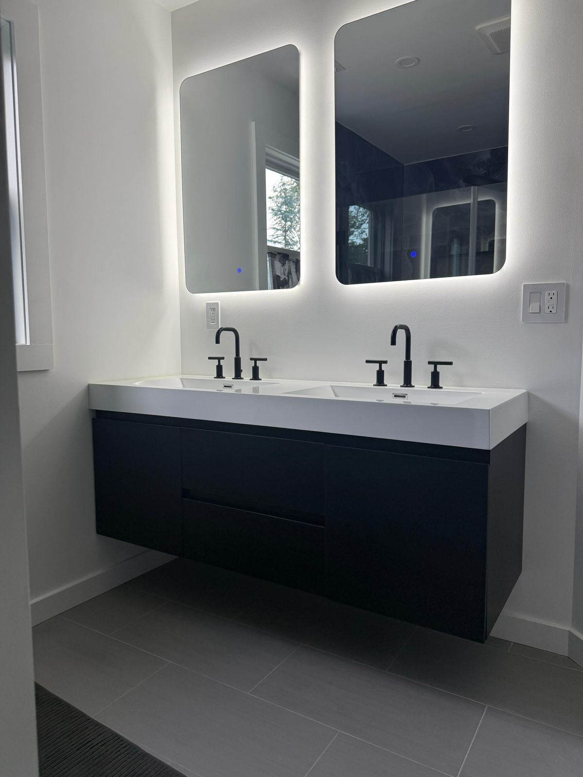 Finished modern primary bath with floating black double vanity
